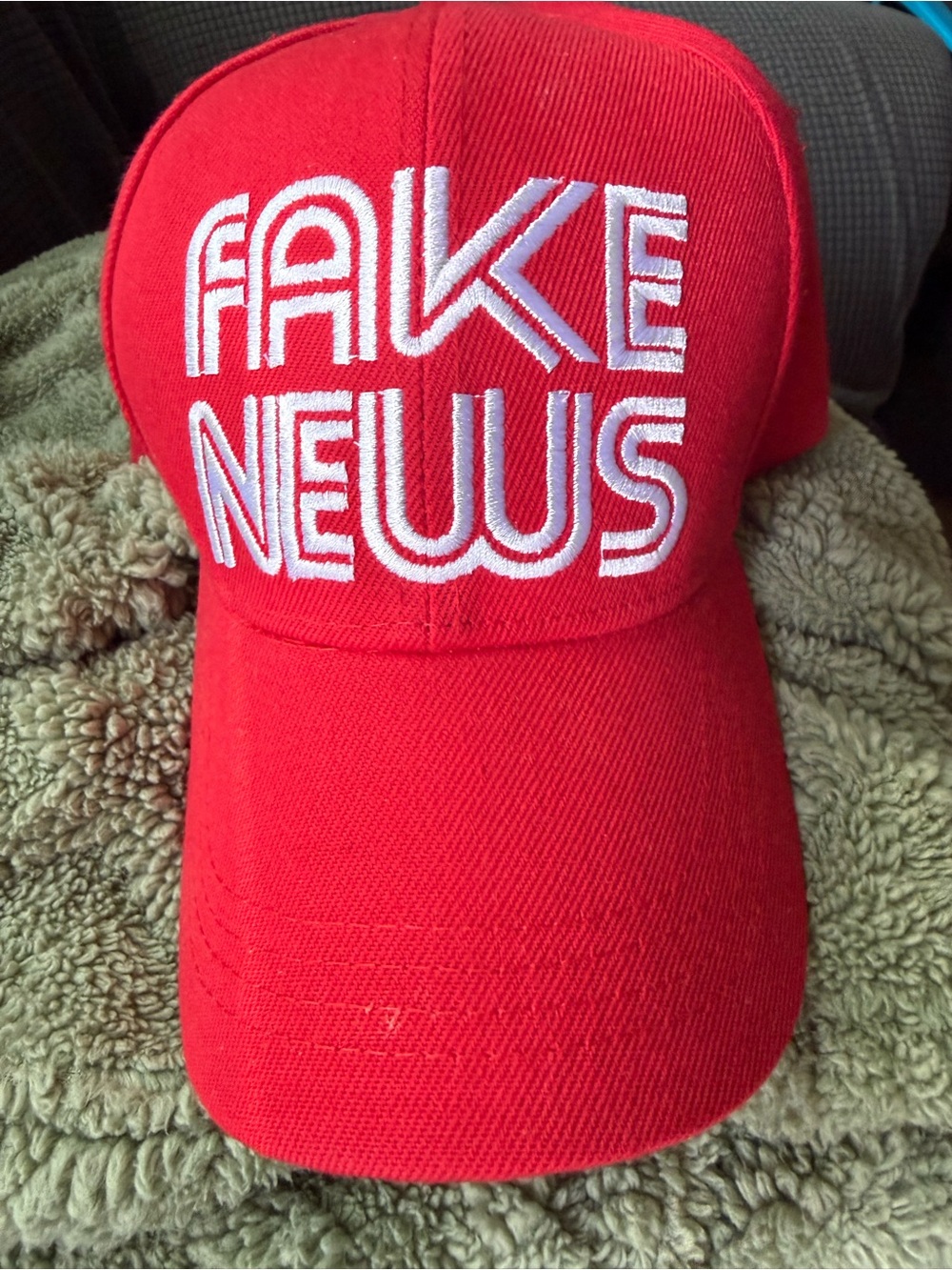 Red Baseball Cap with White 'FAKE NEWS' Embroidery